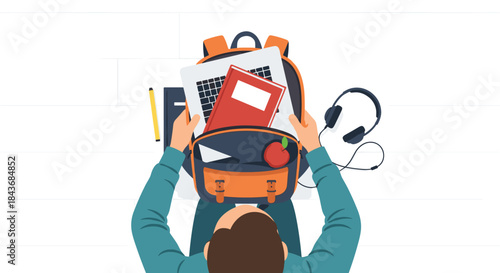 Top view of a student packing a school backpack with a laptop, books, an apple, and headphones for a day of learning.