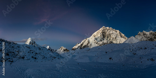 Pumori and Nuptse peaks after sunset in dark twilight, view from Lobuche village. Everest base camp trek, Himalaya mountains, Nepal.