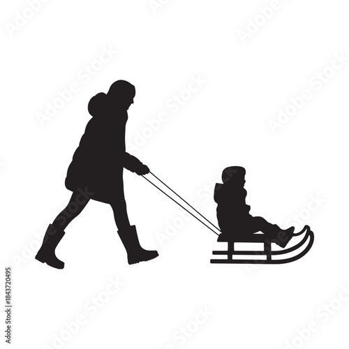 A silhouette of a mother pulling a child on a sled outdoors