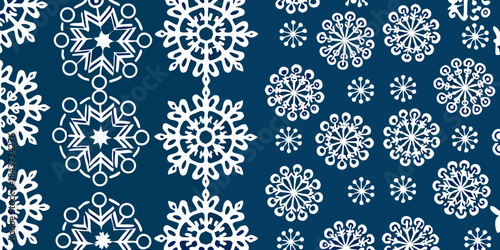 Intricate white snowflake patterns seamlessly repeat on a dark blue background