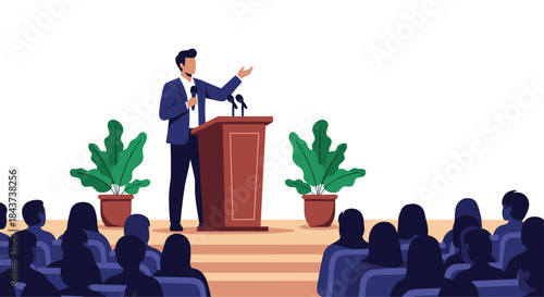 Speaker delivers a public address from a wooden podium to a crowded auditorium with large leafy plants flanking the stage.