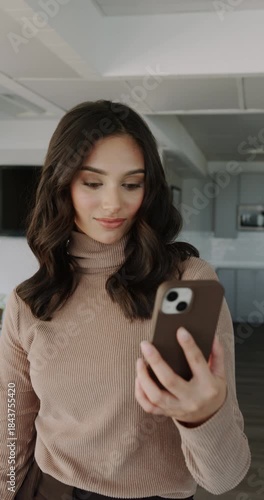 Kitchen woman shares friendly call, Woman with brown hair enjoys lively video conversation from her modern kitchen space