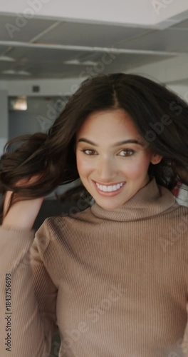 Beautiful brunette girl looks at the camera and smiles, with a very beautiful smile