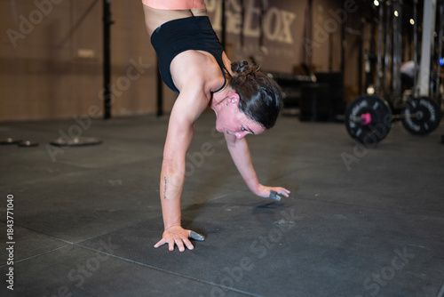 Woman Balances Expertly, Female Performs Precise Handstand Walk, Woman Maintains Controlled Fingertip Handstand Technique, Practicing Advanced Hand Balancing With Focus And Meticulous Control