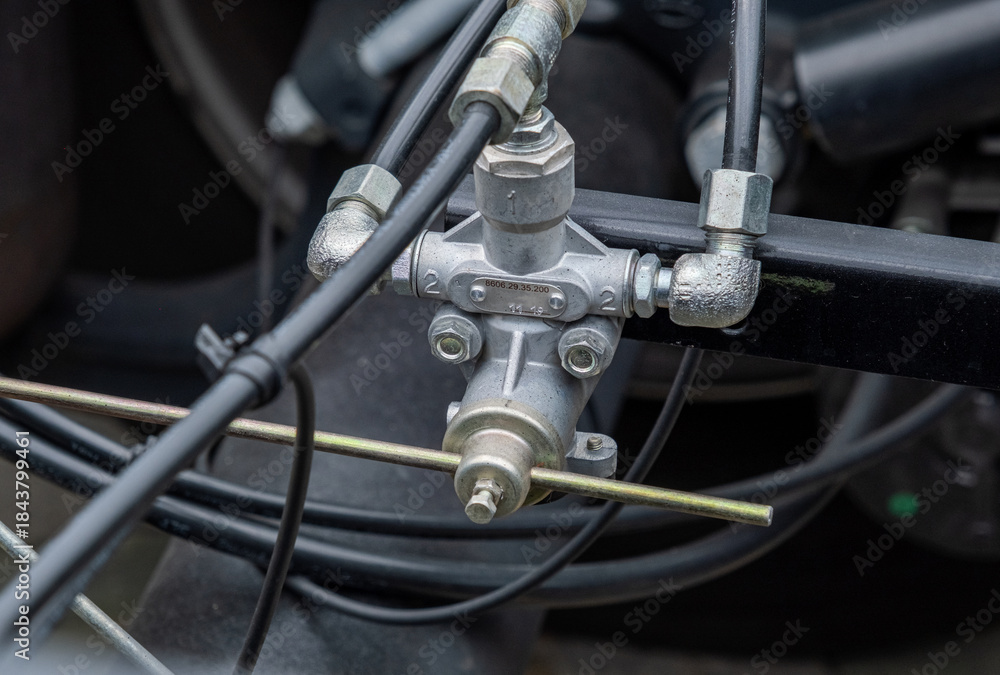 Fototapeta premium Brake system, semi-trailer brake lines, ABS system. Semi-trailer, truck spare parts. Tubes, various fasteners, and auto electronics. View on truck chassis frame equipment. Truck back parts details