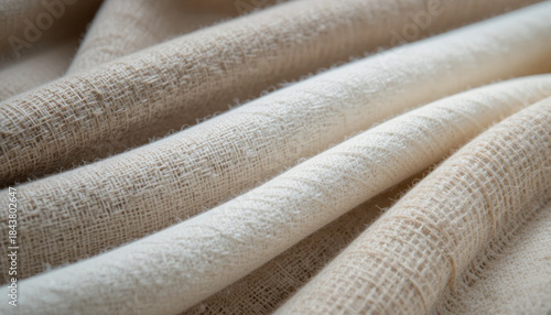 Close up of rolled natural raw cotton fabric showing weave and texture