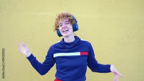 Wallpaper Mural Joyful woman with headphones dancing and listening to music Torontodigital.ca