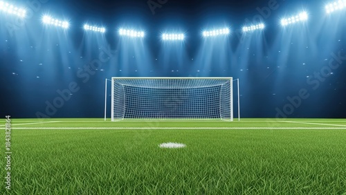 Soccer goal on a grassy field under bright stadium floodlights at night