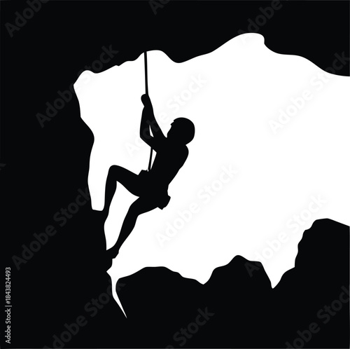 Determined rock climber silhouette scaling a challenging mountain cliff face using ropes