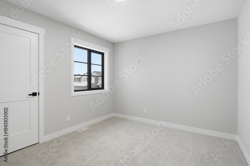 Bedroom with a white door and a window