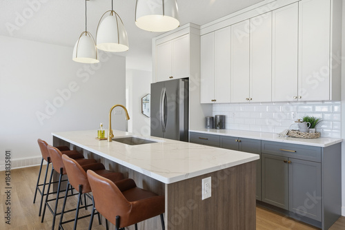 Kitchen with a white counter and a black and brown bar