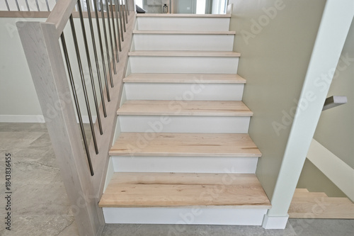 Staircase with wooden steps and a railing