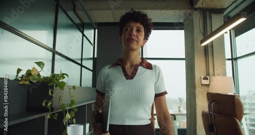 black executive arrives confidently at bright office desk