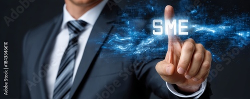 Businessman interacting with digital SME text visualization against a dark background, showcasing innovative technology engagement