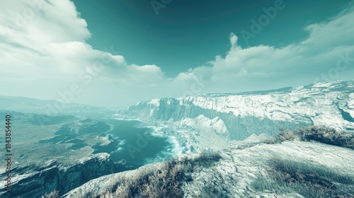 Majestic Snow-Capped Cliffs Overlooking Turquoise Ocean Under a Cloudy Sky