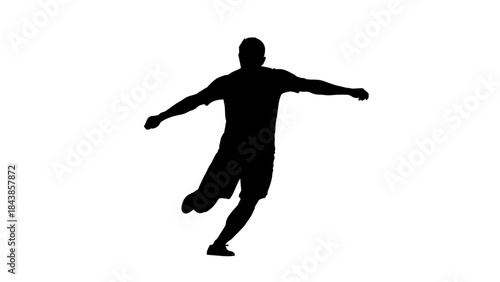 Soccer Player in Silhouette: A dynamic silhouette captures a soccer player in full motion, leg extended for a powerful kick, embodying the spirit of sport and athleticism. 