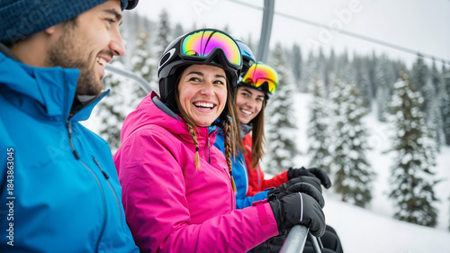 Group of young skiers laughing on ski lift in snowy mountains  