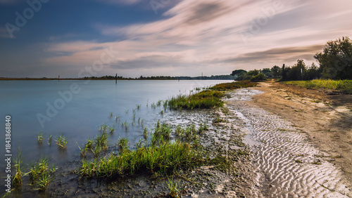 Fototapeta Naklejka Na Ścianę i Meble -  summer sunrise over the lagoon meets the sea, Bibione Pineda, Venice, Italy