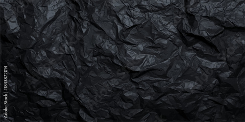 Crumpled black paper texture background with a grunge, wrinkled, and vintage surface sheet pattern