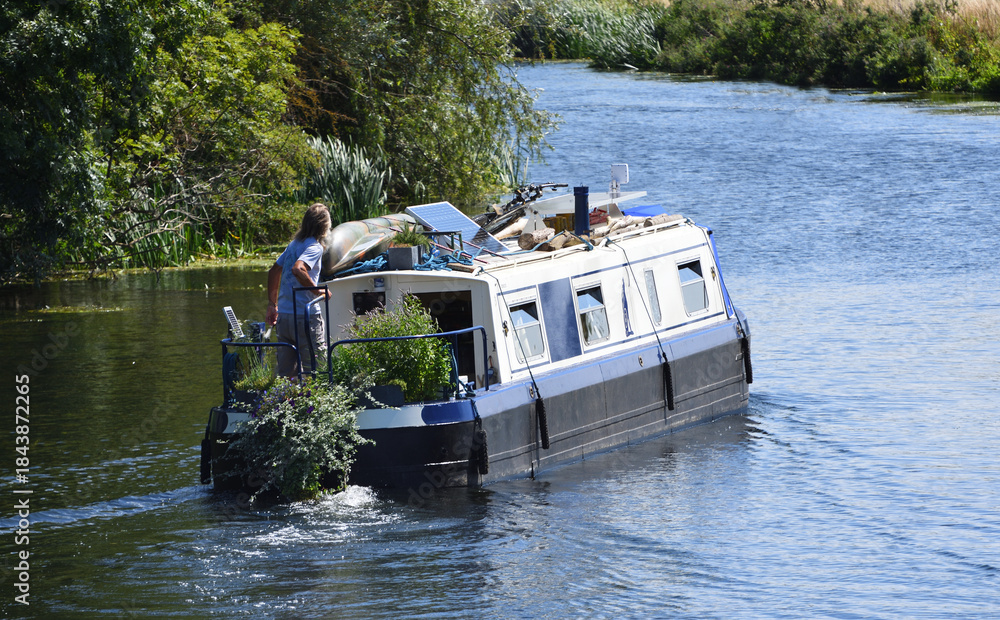 Fototapeta premium Narrow Boat on the river Ouse being used as home,