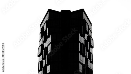 A tall dark building with many windows on a