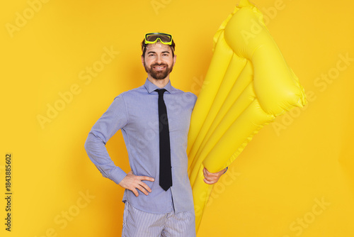 Photos Businessman with diving mask and air mattress on orange background