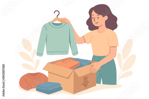 Woman packing clothes into a box for donation with a warm smile