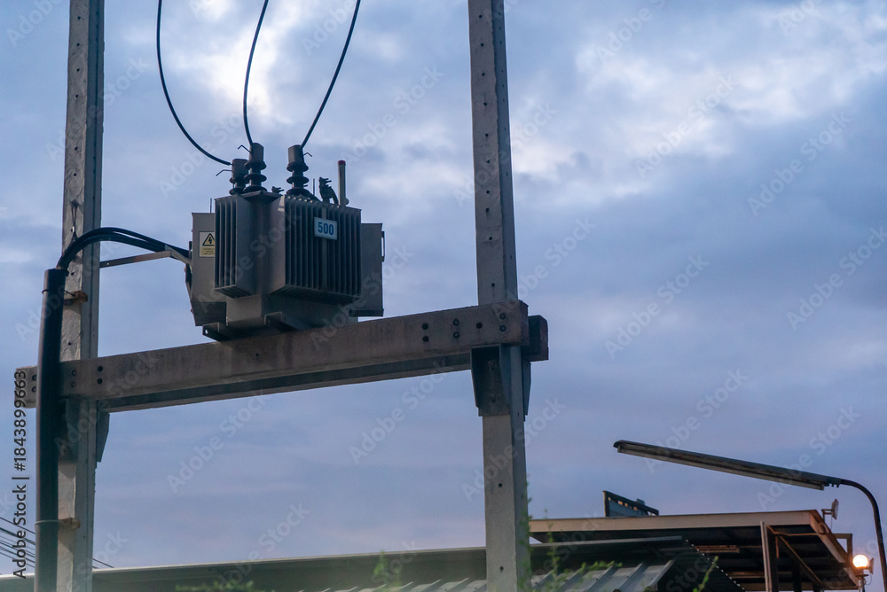 Obraz premium Electrical Transformer against Cloudy Sky