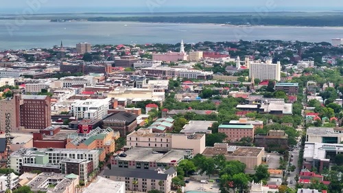 Aerial view of Charleston, South Carolina skyline and cityscape with buildings, parks, church steeples and the waterfront and coastal lowcountry landscape - 4K Drone