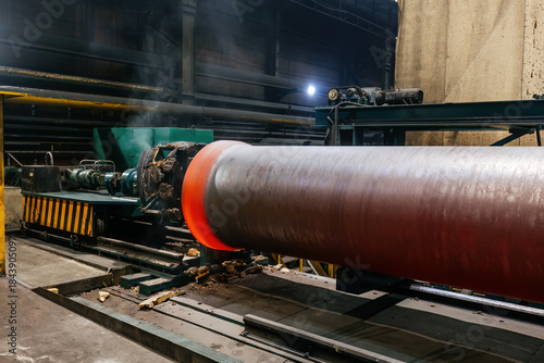 Tableau sur toile Iron pipe centrifugal pipe casting, new red hot freshly cast iron pipe at the fo