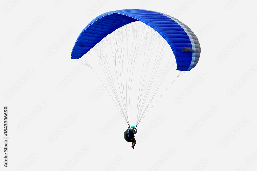 Fototapeta premium The sportsman flying on a paraglider. Beautiful paraglider in flight on isolated white background.