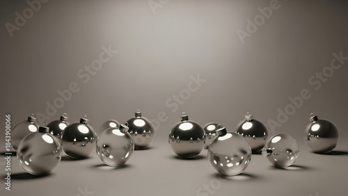 Group of shiny silver spheres arranged on reflective surface in studio environment with soft lighting and shallow depth of field