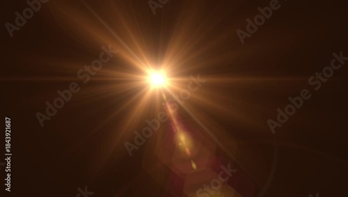 Optical lens flare with warm bokeh effects, golden sunbeam shining brightly, dark background.