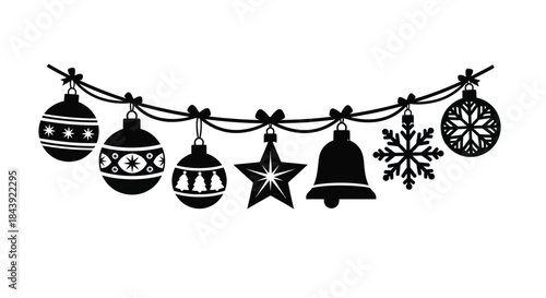 Black and white christmas ornaments and decorations hanging on a string
