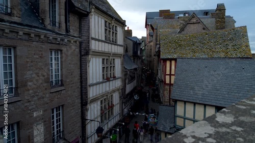 Mont-Saint-Michel, Normandy, 08-24-2024. Medieval houses within the walls of Mont Saint Michel. Panning 4K
