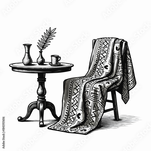 Traditional African Kente fabric draped on a chair beside a table  