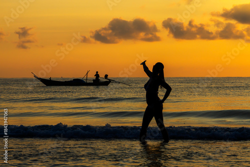 Woman enjoy with sunrise and silhouette