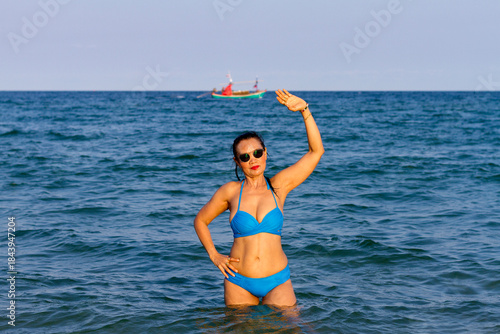 Woman in blue bikini show body pretty