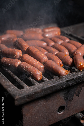 Grilled Sausages Cooking on Barbecue Grill with Smoke