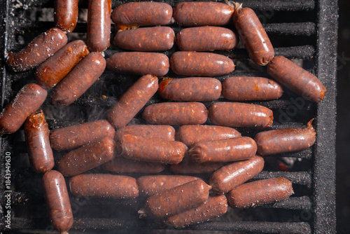 Grilled Sausages Cooking on Barbecue Grill with Smoke