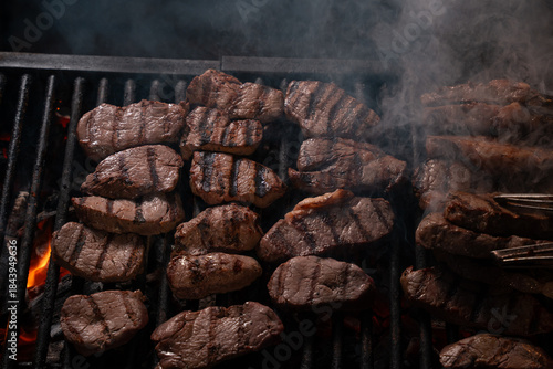 Grilled Beef Steaks Cooking on Barbecue Grill with Smoke