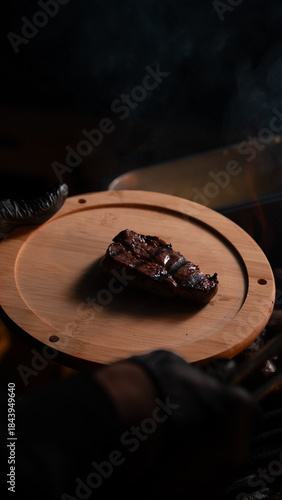 Grilled Steak on Wooden Board with Dark Moody Lighting