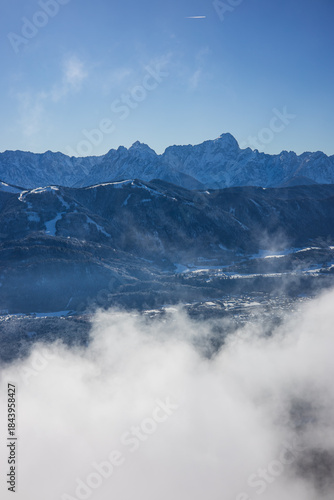 Beauty of the winter Alps seen through rising fog, Austria, with mesmerizing mountain peaks