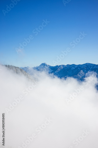 Beauty of the winter Alps seen through rising fog, Austria, with mesmerizing mountain peaks