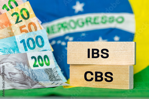 Brazil Finance and taxes. IBS and CBS written on a wooden block IBS. Concept, Brazilian tax reform, simplification of VAT in two local IBS fees for goods and services and the Federal CBS contribution.