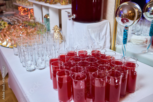 Фотография Casual party refreshment station with vibrant drinks and glassware, Colorful pun