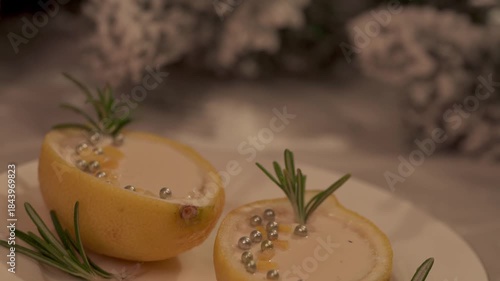 Lemon Posset Dessert Served in Citrus Cups with Rosemary on Festive Table. Pull out shot