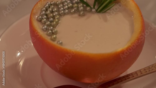 Pull out Macro Shot of Creamy Orange Posset with Pearls
