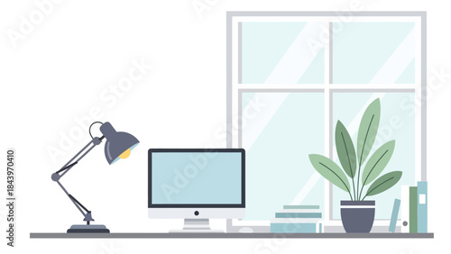 Cozy workspace with modern computer monitor and desk lamp by a sunlit window