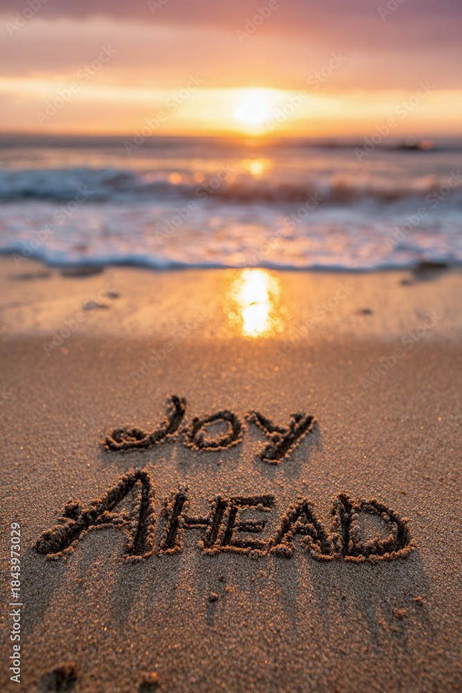 Fototapeta premium Joy Ahead Tidy Natural Handwriting in Sand with Meticulously Shaped Letters and Bright Golden Sun at Horizon – perfect for motivational prints